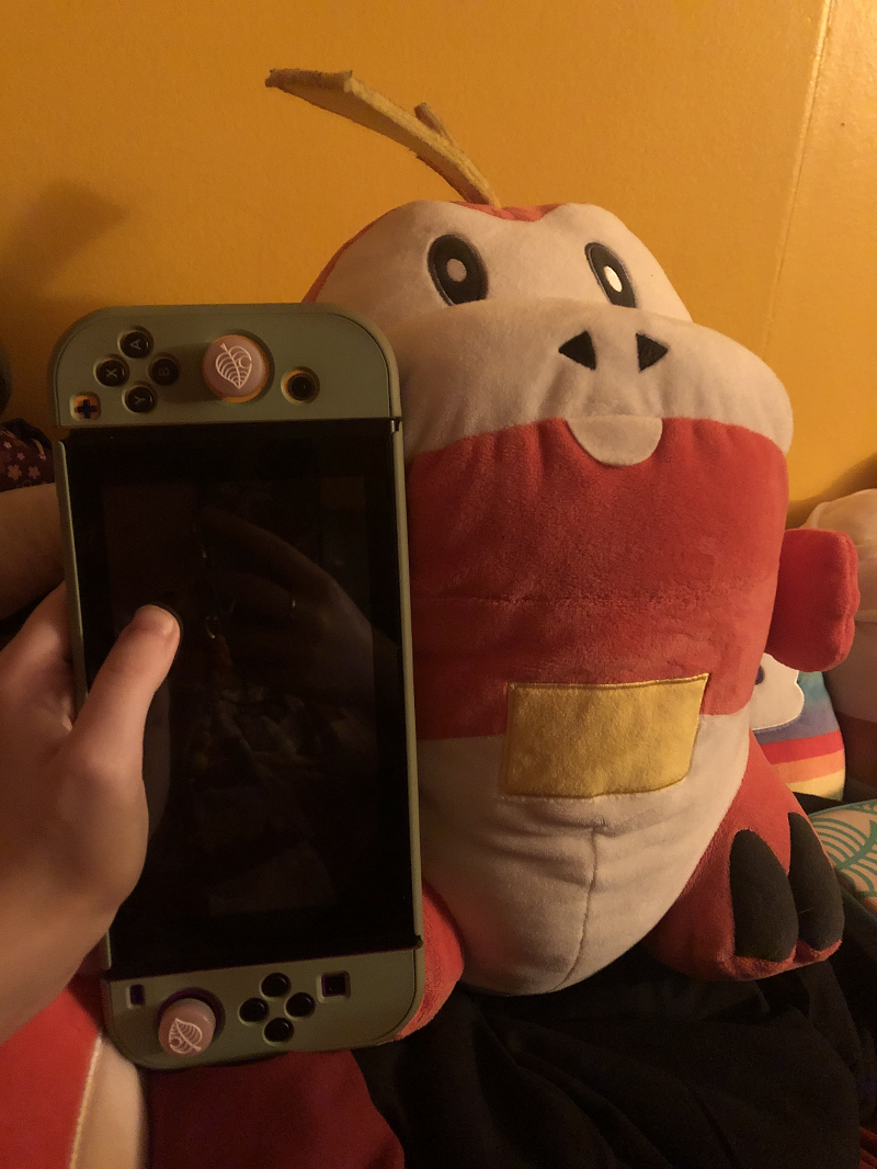 an image of the BAB fuecoco next to an nintendo switch, showing he is roughly 1 1/4ths switch tall